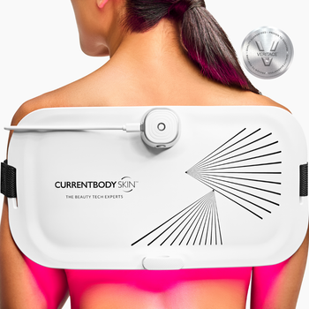 Woman wearing the CurrentBody Skin LED Light Therapy Panel on her back.